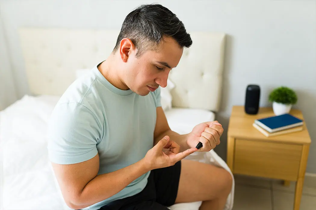 Man taking glucose reading while in Home-based primary care