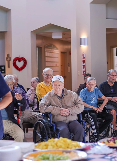 Two elderly veterans saluting at learning event for veterans hospice care