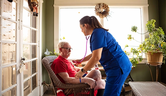 Elderly man with nurse who is receiving home health services in Horizon City
