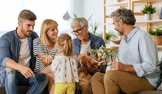 Family laughing on couch