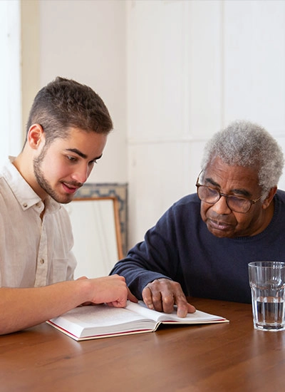 Volunteer and elderly man reviewing hospice care information