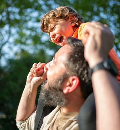 Child on father's shoulders