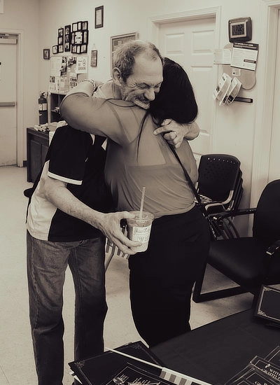 Woman hugging older man who is in hospice in El Paso